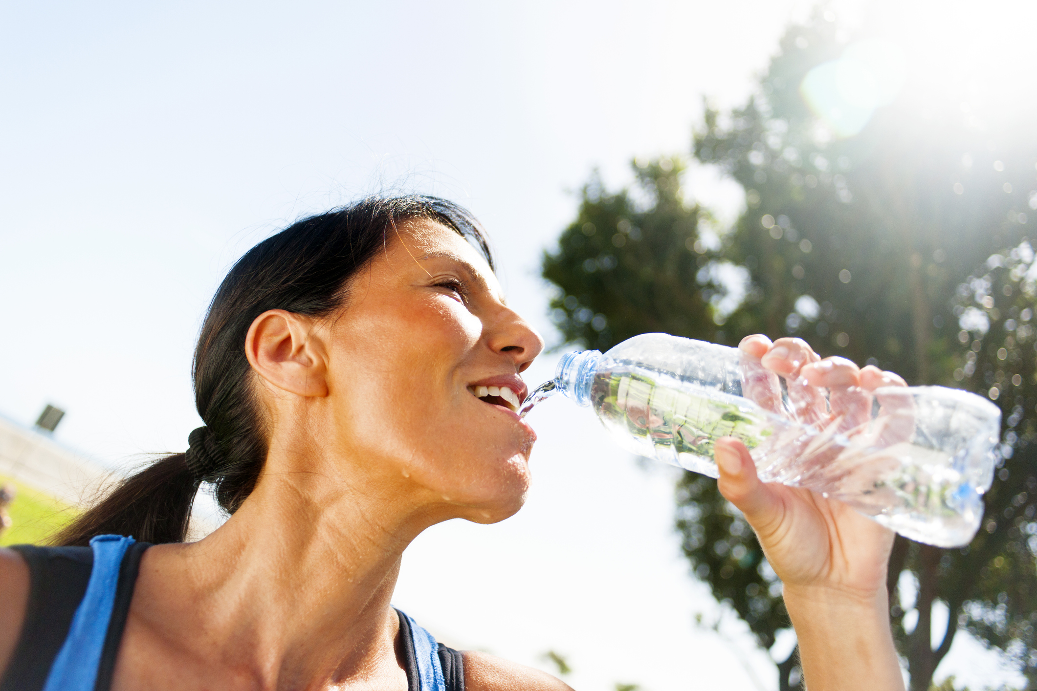 Female jogger drinking water